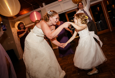 Wedding photography, the bride dances with a small flower girl. 