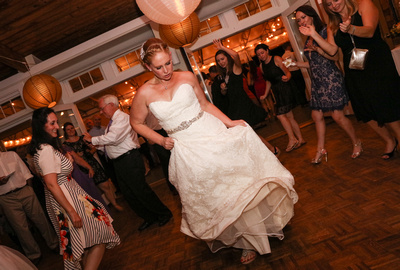 Wedding photography, the bride in a white lace gown dances on the dance floor. 