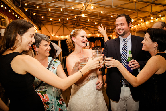 Wedding photography, the bride toasts a shot with her friends. 