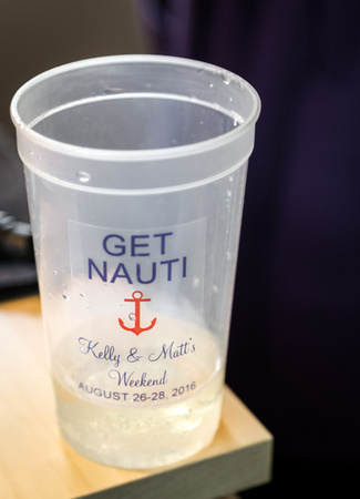Wedding photography, a plastic cup that says "Get Nauti" with a red anchor and the bride and groom's names. 