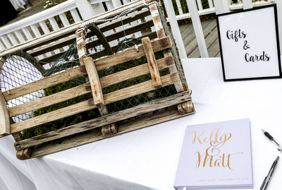 Wedding photography, the gift table has a nautical theme with a lobster trap for cards. 