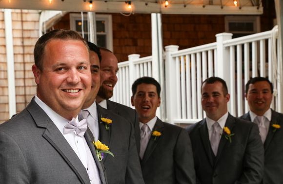 Wedding photography, a groom smiles with his groomsmen just before the ceremony starts.  