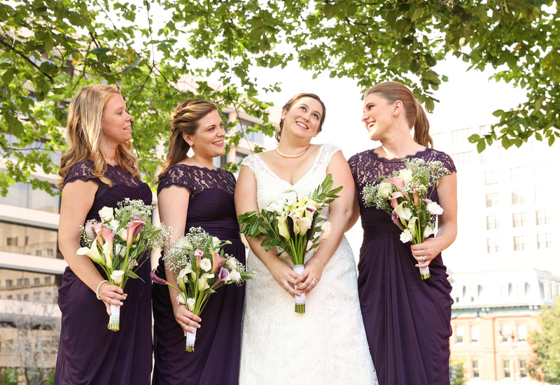 Wedding photography, a bride and bridesmaids smile with tulips bouquets. 
