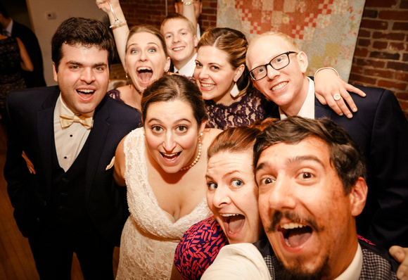 Wedding photography, the wedding party takes a selfy with their photographers. 