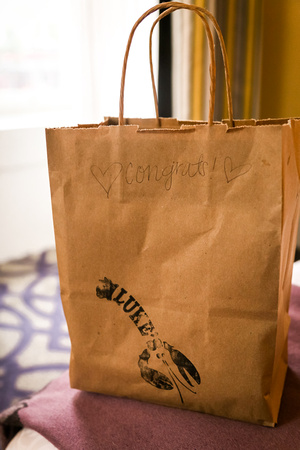 Wedding photography, a brown bag filled with lobster rolls. 