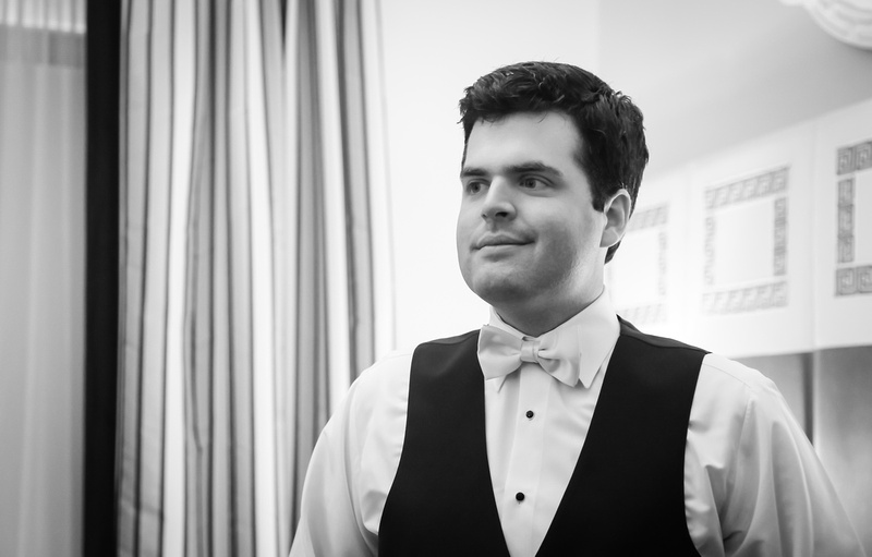 Wedding photography, a groom smiles in his wedding tux. 
