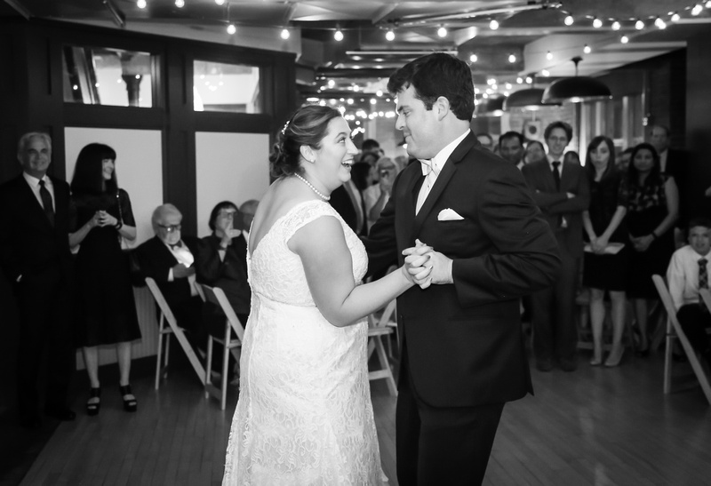 Wedding photography, a bride and groom dance playfully while their guests watch and smile. 