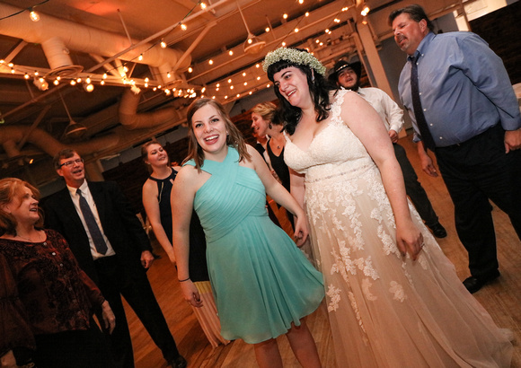 Wedding photography, the maid of honor and bride smile on the dance floor. 