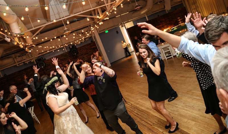 Wedding photography, the bride and groom dance and celebrate with their friends. 