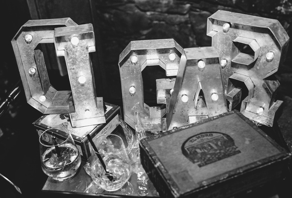 Wedding photography, a black and white image of CIGAR display letters and empty glasses. 