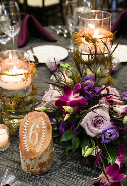 Wedding photography, a table setting with birch bark table numbers and purple florals. 