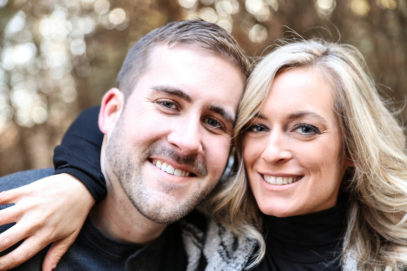 Engagement photography, a close-up shot of two fiancés smiling. She has long blonde hair. 