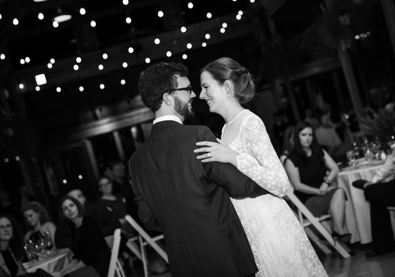Wedding photography, a couple smiles while they share their first dance. 