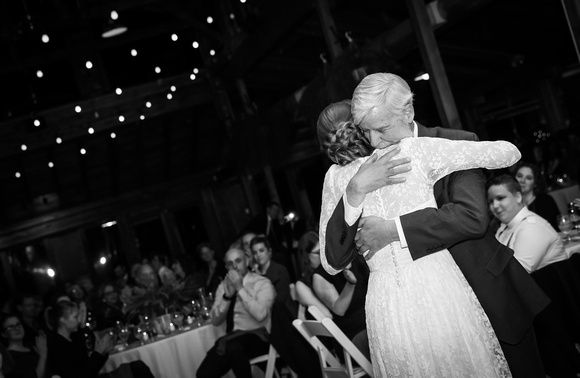 Wedding photography, a bride hugs her father sweetly. 