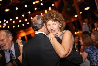 Wedding photography, a woman with curly hair dances tenderly with her husband. 