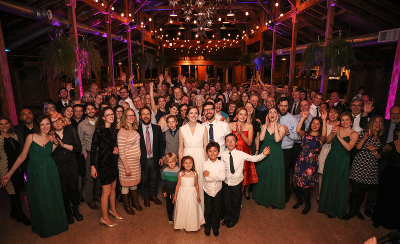 Wedding photography, a bride and groom pose with all of their wedding guests. 