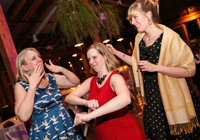 Wedding photography, a group of blonde woman dance and act silly. 