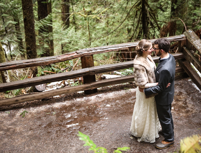 Wedding photography, a bride and groom hold each other romantically in the woods. 