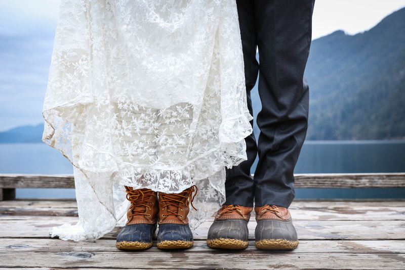 Wedding photography, a bride and groom wear duck boots on a dock in Washington. 