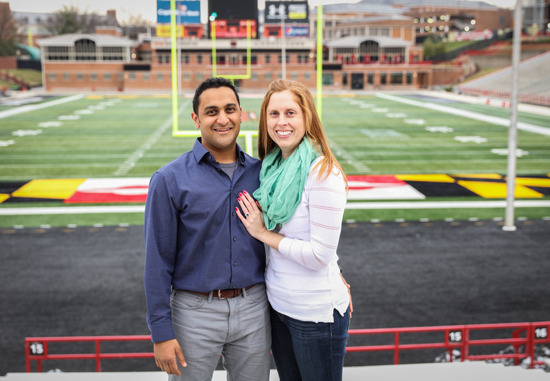 Engagement photography, a couple poses by the goal post on a college football field. 
