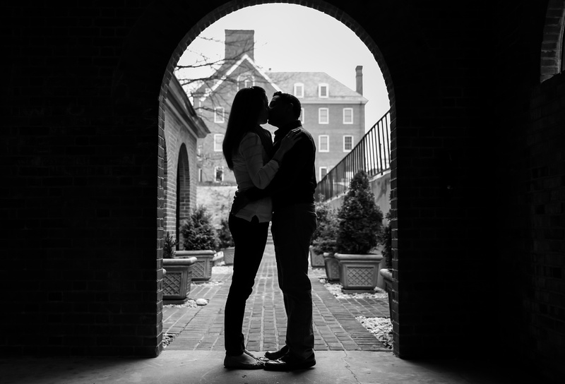 Engagement photography, a silhouette of a couple kissing in an archway, 
