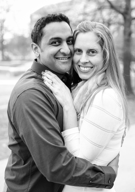Engagement photography, a couple smiles at the camera with their faces pressed together. 