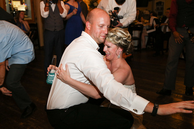 Wedding photography, the bride and groom dance all the way down to the dance floor. 