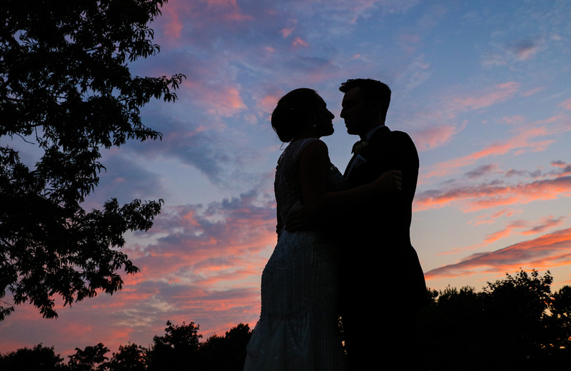 Wedding photography, a pink and blue sunset with two lovers in silhouette.  