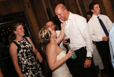 Wedding photography, the bride lovingly touches the grooms face on the dance floor. 