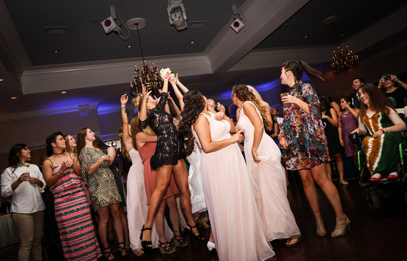 Wedding photography, a group of girl jump for the bouquet. 