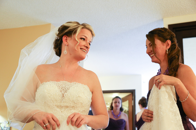Wedding photography, a bride and her bridesmaid smile with excitement. 