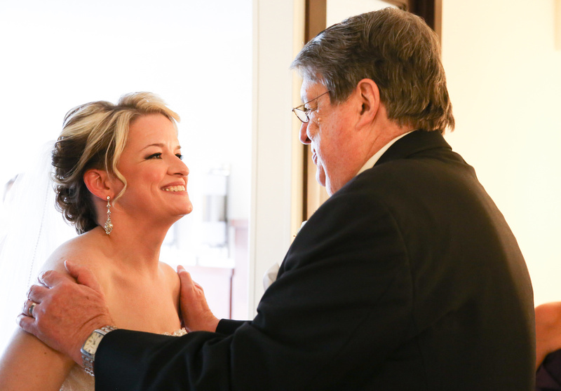 Wedding photography, a bride and her father share a look of love just before the ceremony. 