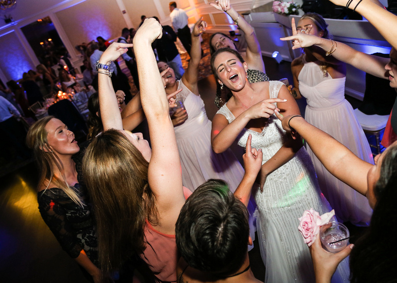 Wedding photography, the bride sings her heart out while surrounded by girlfriends. 