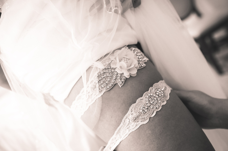 Wedding photography, a closeup of a bride's leg wearing two garters. 