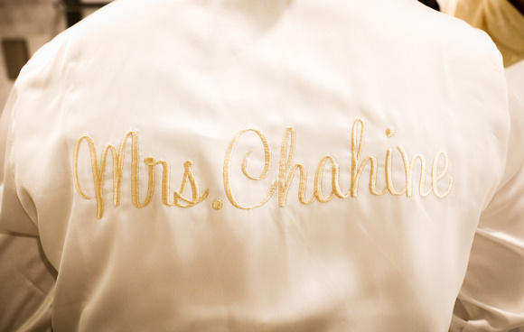 Wedding photography, a white silk robe with gold lettering, "Mrs. Chahine." 