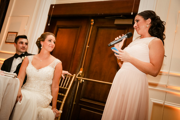 Wedding photography, a bride shares a tear-filled look with her sister as she gives a speech. 
