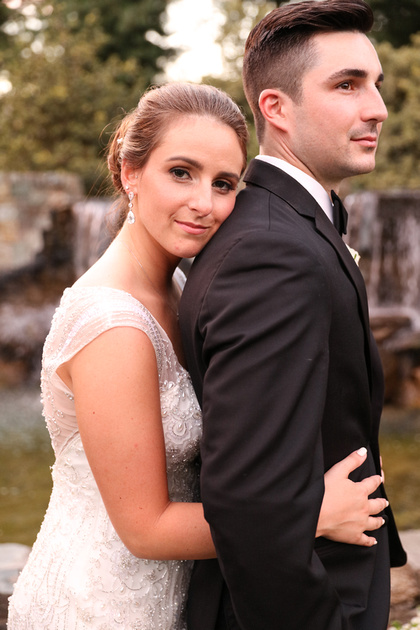 Wedding photography, a bride romantically rests her head on her groom's shoulder. 