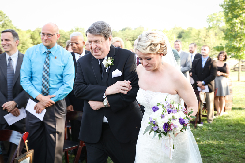 Wedding photography, a bride cries tears of joy as her father walks her down the aisle. 