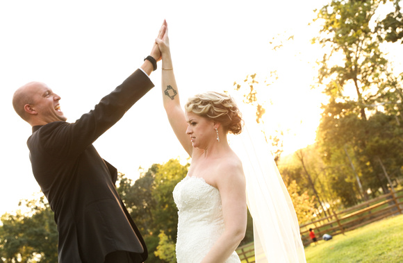 Wedding photography, the bride and groom triumphantly high five. 