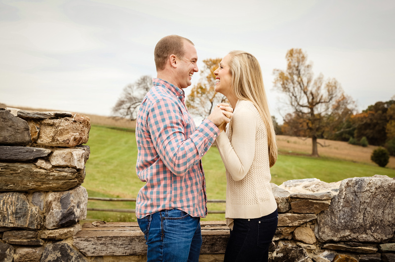 Engagement photography, a couple holds hands and laughs. 